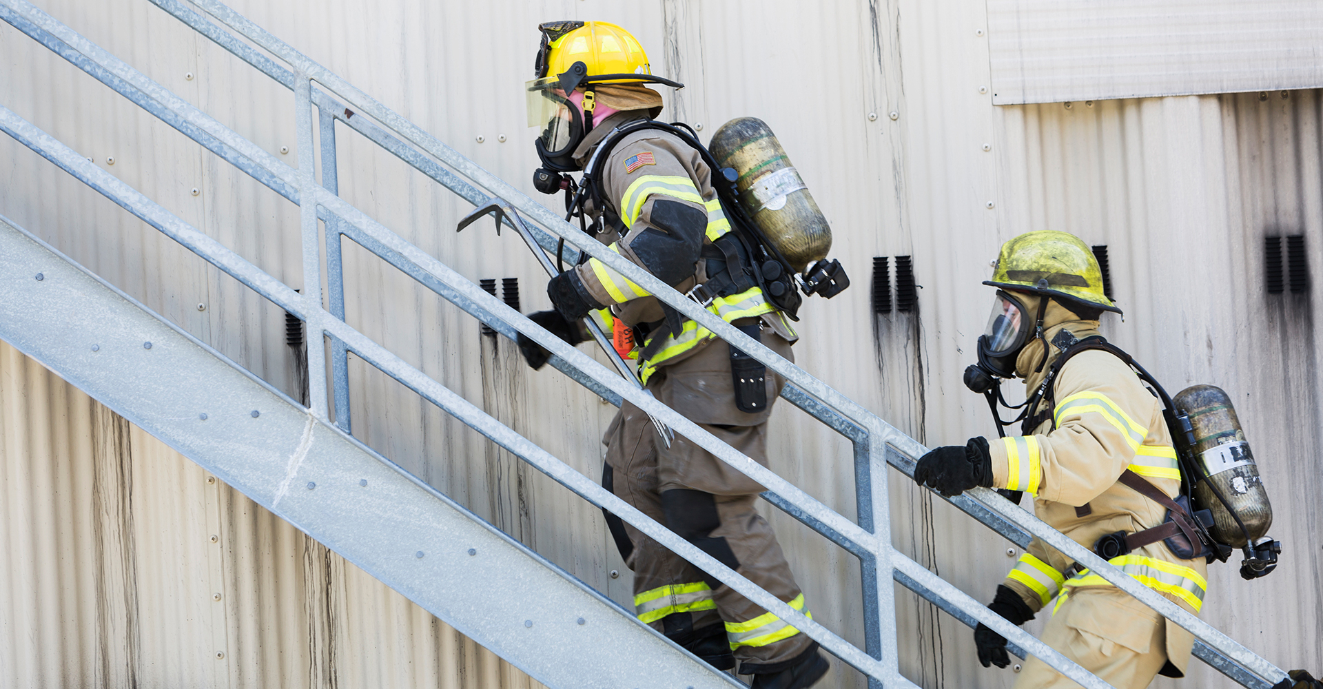 Two firefighters walking up stairs