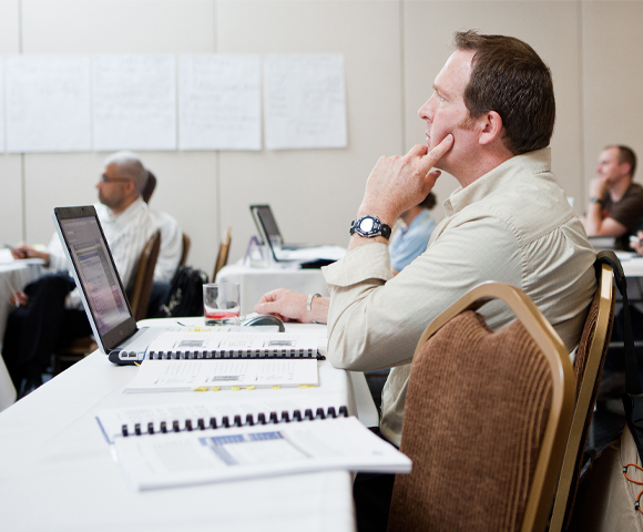 Man listening to course instructor