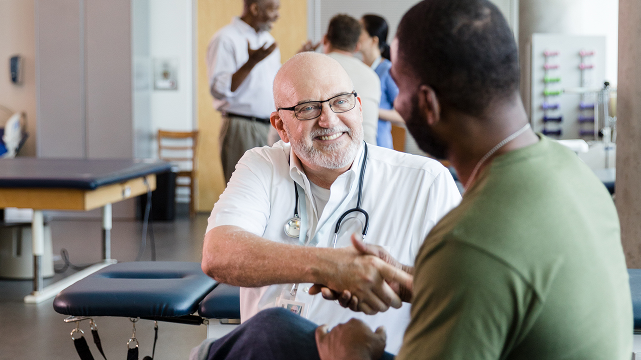 Therapist and patient shaking hands