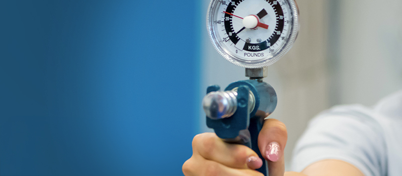 Woman squeezing dynamometer