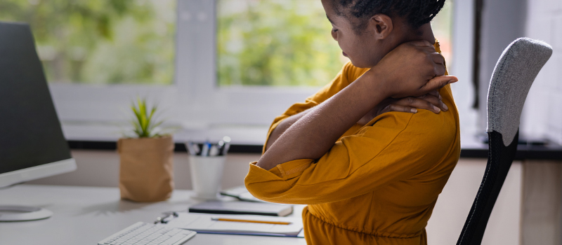 Remote employee with neck pain at desk