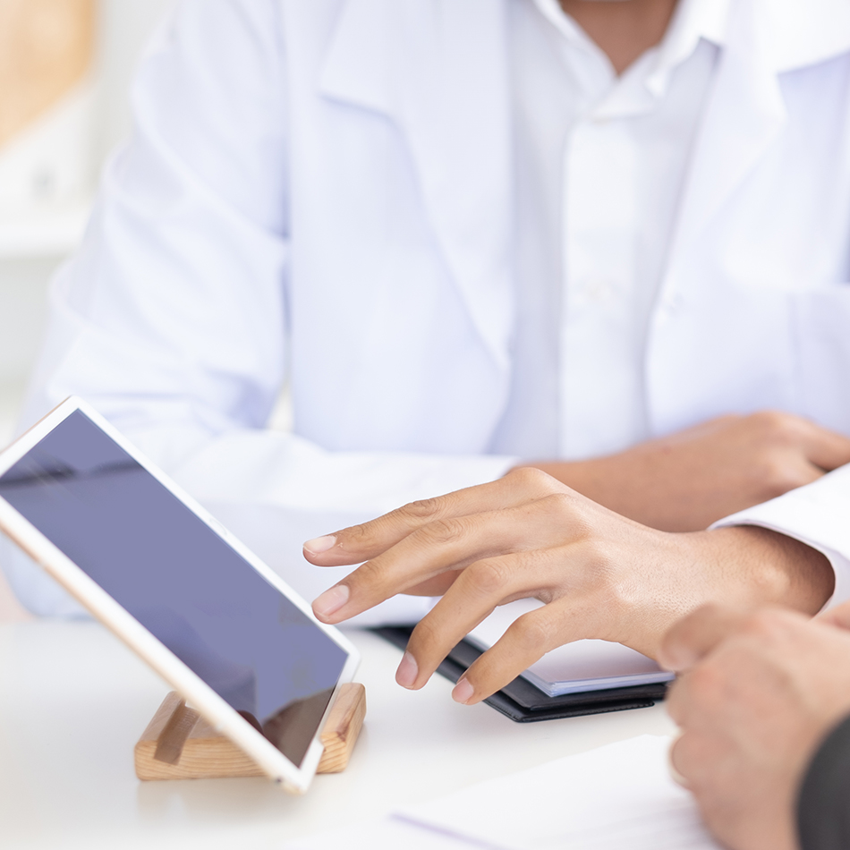 Doctors pointing to tablet