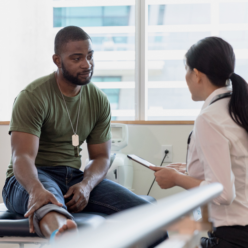 Soldier with injured foot talking to therapist
