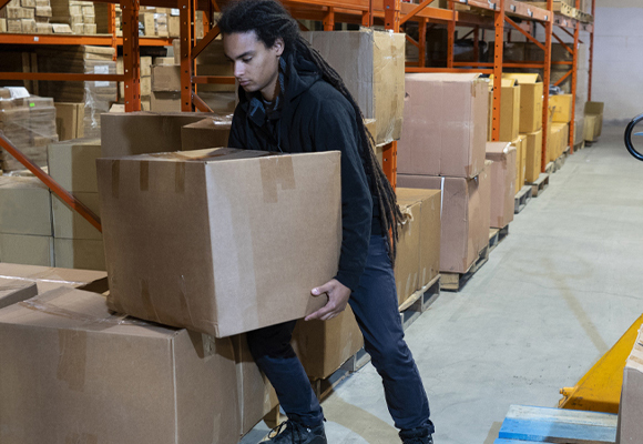 Employee lifting brown box