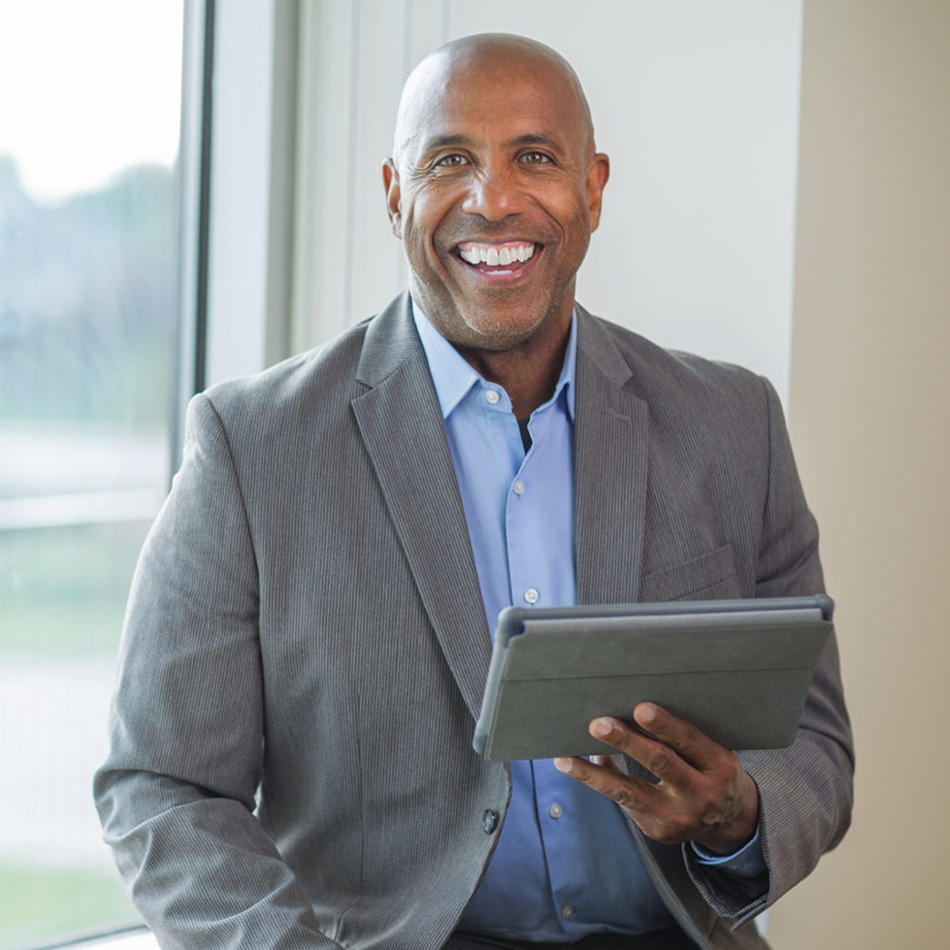 Therapy owner smiling holding tablet