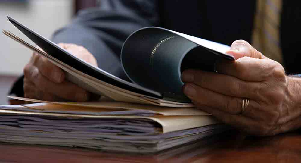 Man reading reports for reliability and validity research