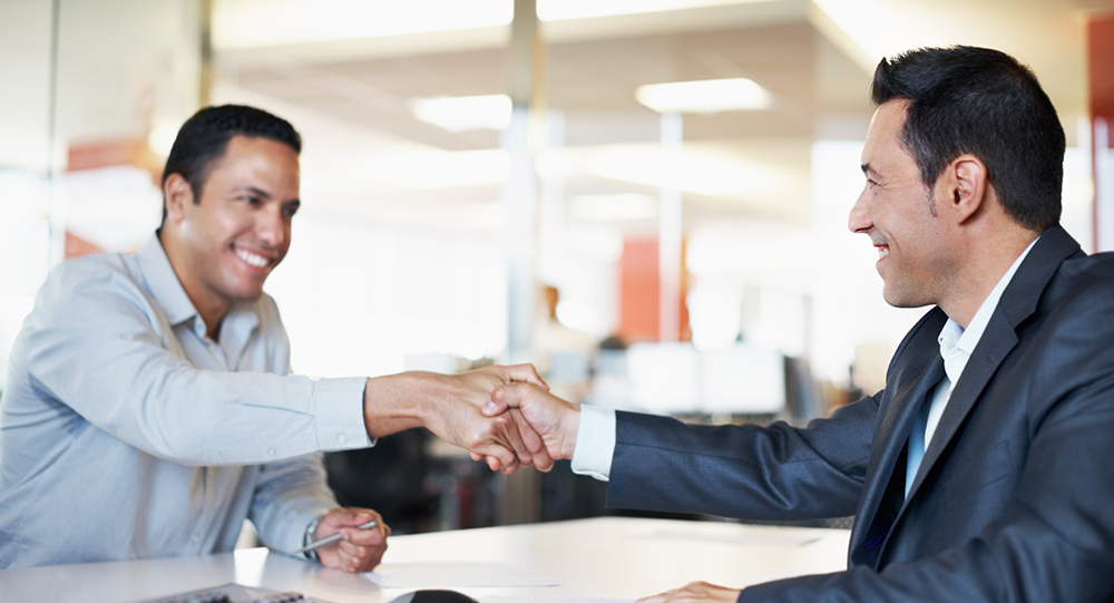 Men shaking hands after agreeing on contract